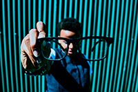 Boy holding spectacles in his hand