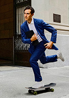 Business man in a suit skateboarding in the street