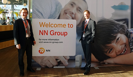 Staff members at the NN Group billboard
