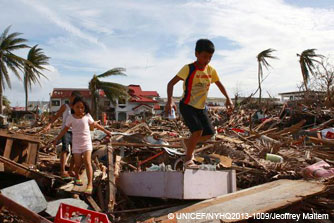 Tacloban City, 10 November: children make their way through <br />the ruins of flattened homes.