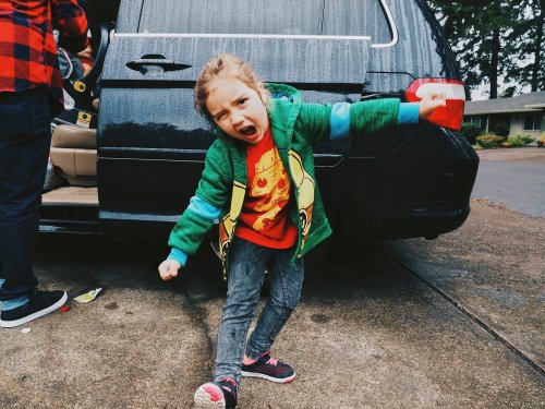 Girl in front of car screaming
