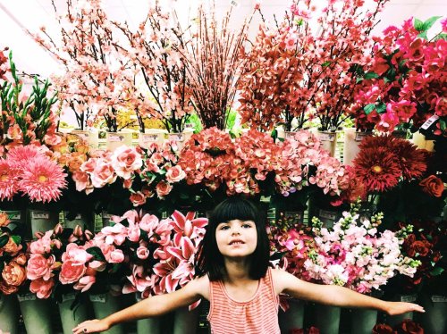 girl in front of pink flowers